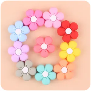 Detailed close-up of colorful floral silicone teething charms in soft macaron shades