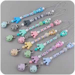 Detail of colorful silicone pacifier clips with cartoon bear and letter beads