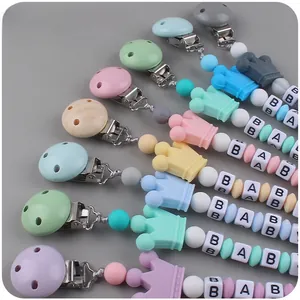 Detail of colorful silicone pacifier clip with baby letter beads and crown design