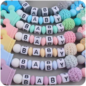 Detail of DIY baby pacifier clips with silicone beads, crochet balls and cartoon bear charms