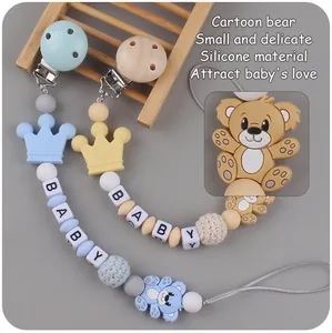 Close-up of silicone pacifier clip set with cartoon bear beads and baby letter cubes
