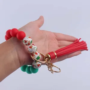 Christmas beaded wristlet keychain with red tassel and festive leopard print beads