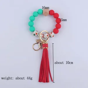 Christmas-themed beaded wristlet keychain with red green beads and a red leather tassel
