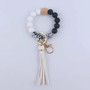 Close-up of leopard print silicone beads and white leather tassel on a wristlet keychain