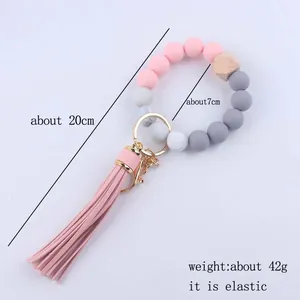 Macaron siliconen kralen sleutelhanger met roze kwastje en gouden sluiting, circa 20 cm lang