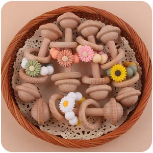 Close-up of beech wood baby rattles with daisy silicone beads in a woven basket