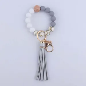 Detail of leopard print silicone beads and grey PU leather tassel on a key ring