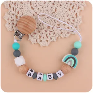 Siliconen speenkoord met mintgroene kralen, BABY-letters en een regenboog hanger