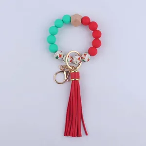 Close-up of beaded wristlet keychain with silicone beads, wood bead and red leather tassel