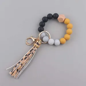 Detail van de luipaardkwast en siliconen kralen aan de elastische armband-sleutelhanger