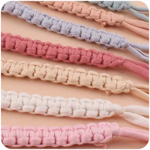 Detailed close-up of handmade woven cotton pacifier clips in various pastel colors
