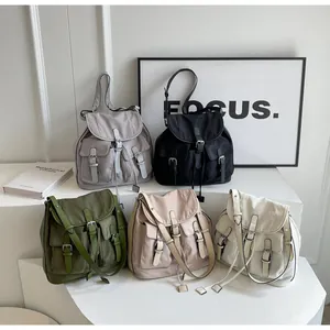 Close-up of functional pockets and metallic buckle on canvas multi-pocket casual backpacks