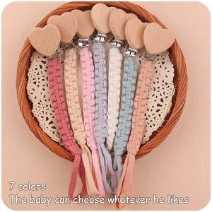 Set of seven handcrafted cotton braided pacifier clips with beech wood heart shaped clips