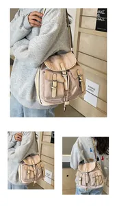 Detail view of khaki nylon backpack featuring buckle pockets and leather straps