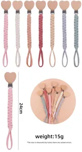 Detail view of colorful hand-woven pacifier clips in seven shades with beech wood hearts