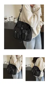 Detail of black multi-pocket canvas utility bag showing versatile strap and vintage pockets