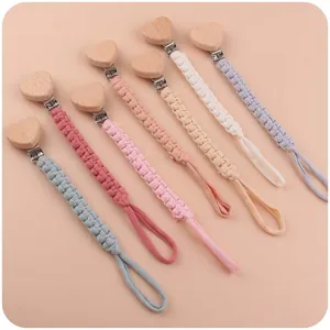 Handmade beechwood heart pacifier clips in various Morandi colors with braided cords