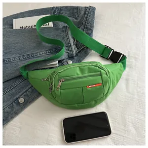 Macro view of green canvas waist bag with multi-layer zippers and durable sport nylon