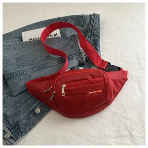 Detail of red canvas waist bag with adjustable strap, plastic buckle and SPORT logo
