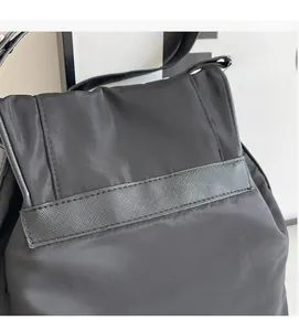 Detail of soft black canvas fabric and textured strap on a vintage casual bag