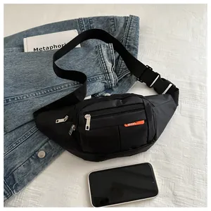Detail of black canvas waist bag showing multi-layer zippers and orange sport label