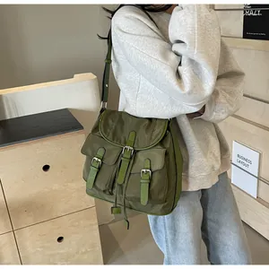 Detailed side view of military green nylon backpack with functional multi-pocket design