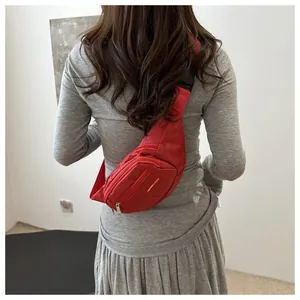 Detail of red canvas waist bag with multi-layer zipper pockets and sport tag on back