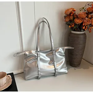 Detail showing silver mirror tote bag with metallic texture and buckle belt accents