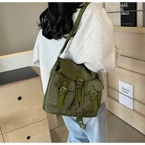 Model view of an army green nylon multi-pocket messenger bag with buckle closures