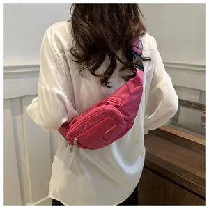 Detail view of pink canvas waist bag with adjustable strap and sport logo engraving