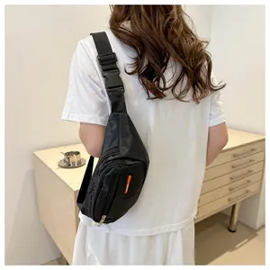 Detail showing high-capacity black waist bag with quilted pattern and adjustable sport strap