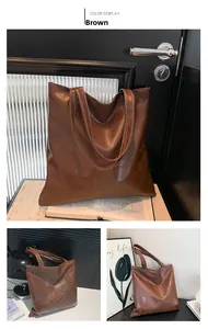 Detail of brown faux leather tote bag with square woven texture and long slim straps