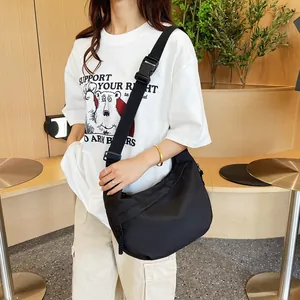 Detail of black crescent crossbody bag with adjustable wide strap for daily casual style