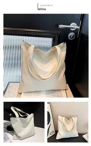 Detail of white tote bag featuring geometric stitching and premium leather texture