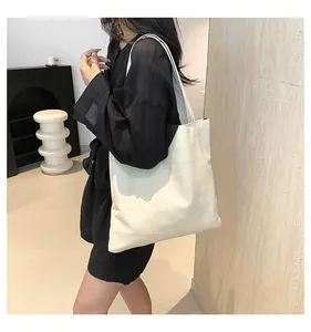Close-up of minimalist white tote bag with geometric texture on a sleek display stand