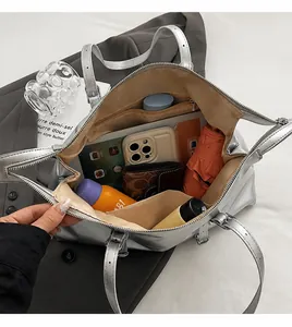 Top view of silver tote bag interior showing large capacity for essentials like tablet and phone