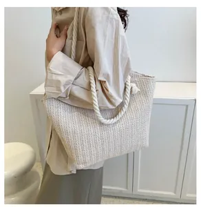 Detailed close-up of woven herringbone texture and thick cotton rope handle on tote bag