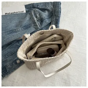 Internal view of beige woven tote bag showing zippered pocket and spacious storage