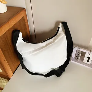 Detail of white nylon half-moon crossbody bag with black adjustable strap and plastic buckle
