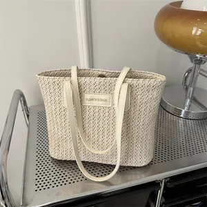 Minimalist cream straw tote bag with V-shaped weave and elegant leather straps