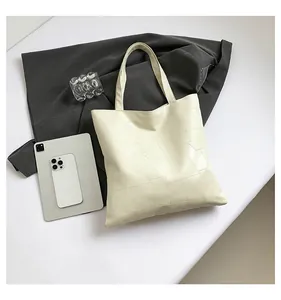 Detail view of cream-colored quilted tote bag with geometric stitching and large capacity