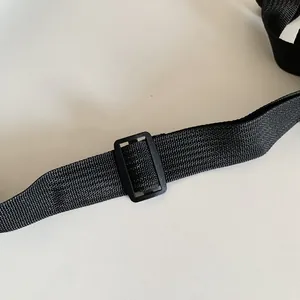 Detailed close-up of a durable black nylon strap with an adjustable plastic buckle