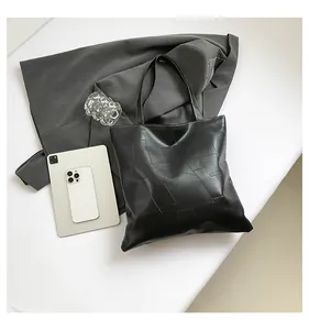 Detail of black geometric pattern PU leather tote bag with long handles for office use
