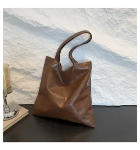 Detail of square quilted stitching on dark brown faux leather oversized tote bag