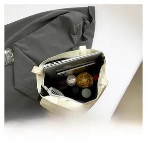 Top view of cream tote bag showing large capacity for laptop, tablet, and daily items