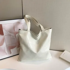 Minimalist cream tote bag with geometric quilted texture for women's casual daily commute