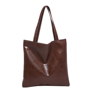 Retro dark brown tote bag with geometric textured pattern and durable shoulder straps