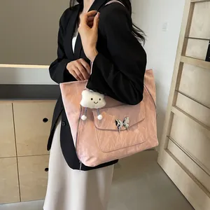 Pink textured tote bag detail featuring silver butterfly buckle and white cloud charm