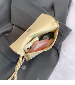 Straw woven bag interior with magnetic closure showing storage for phone and makeup