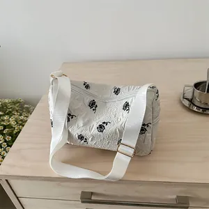 Chic white pleated shoulder bag with black rose prints and adjustable wide strap